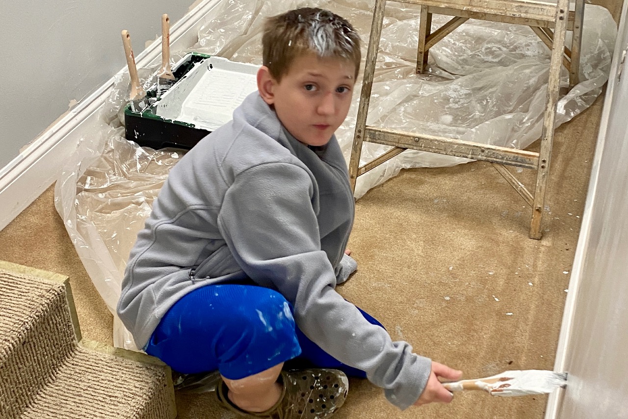Jackson helping to paint the education building.
